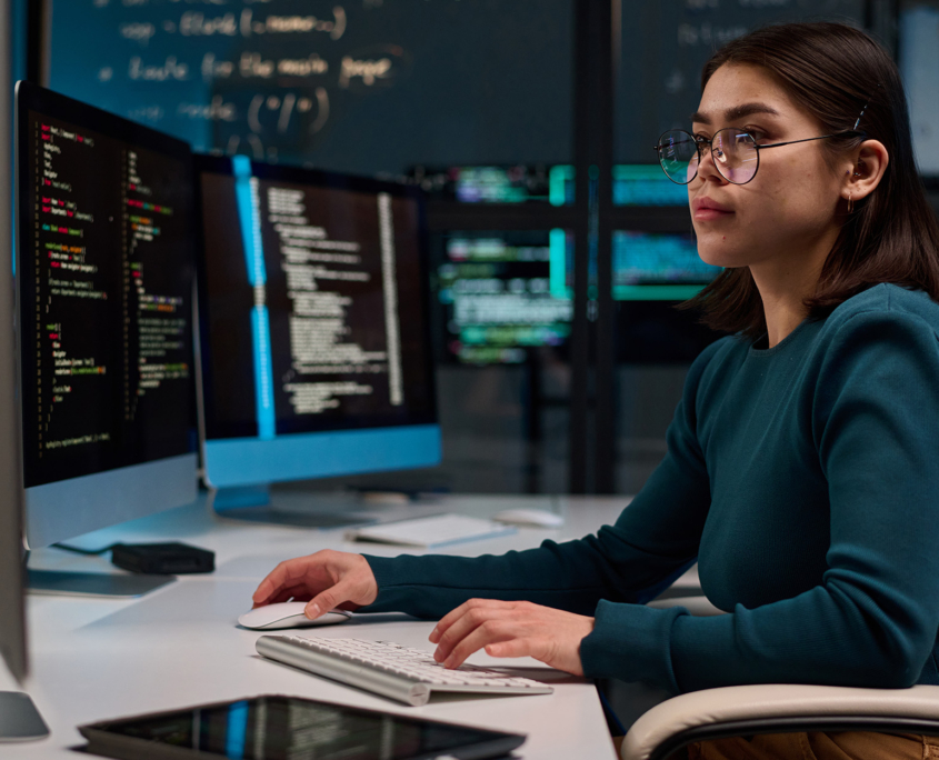Woman Typing Code On Computers